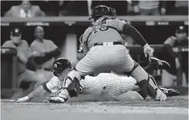  ?? GETTY IMAGES ?? Brett Gardnerof the Yankees slides in safely pastBrian McCann of the Astros at home plate to score on a double by Aaron Judge on Wednesday.