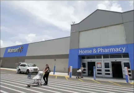  ?? ALAN DIAZ — THE ASSOCIATED PRESS ?? Customers walk out of a Walmart store in Hialeah Gardens, Fla.