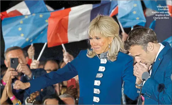  ?? ?? Victory kiss: Emmanuel Macron with wife Brigitte at the Champ de Mars