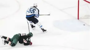  ??  ?? Minnesota Wild forward Mikael Granlund, left, couldn’t catch Winnipeg Jets centre Mark Scheifele before he deposited the puck into an empty net for his second goal of the game to clinch a 2-0 Winnipeg victory.