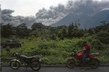  ?? Santiago Billy / Associated Press ?? Volcan de Fuego, or Volcano of Fire, blows outs a thick cloud of ash, as seen from Alotenango, Guatemala.