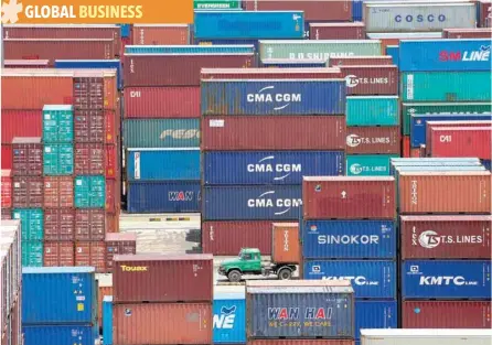  ?? — Reuters ?? Shipping containers are seen at a port in Shanghai, China.