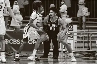  ?? Michael Conroy / Associated Press ?? Butler guard Myles Tate, left, helped hold Jermaine Samuels and Villanova to just one basket over the final seven minutes of the first half, and the Bulldogs never trailed again.