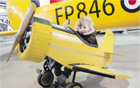  ??  ?? Above: A young aviation fan checks out an appropriat­ely sized plan during a previous open house at the B.C. Aviation Museum. This year’s open house runs 10 a.m. to 4 p.m. Saturday at 1910 Norseman Rd. in North Saanich.