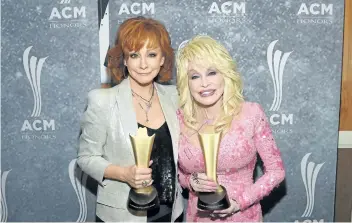  ?? RICK DIAMOND/GETTY IMAGES ?? Honorees Reba McEntire and Dolly Parton attend the 11th Annual ACM Honors at the Ryman Auditorium on Thursday in Nashville, Tenn.
