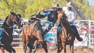  ?? Jordan Bradley gets a lift after riding eight seconds in the Station Buckjump. ??