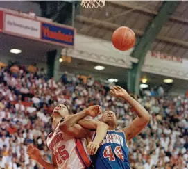  ?? AP FILE ?? WAITING FOR THE REBOUND: Syracuse's LeRon Ellis (25) and Richmond's Kenny Wood (44) lock arms as they watch the ball get away during the first half and an NCAA college basketball East Regional game in College Park, Md. in 1991.