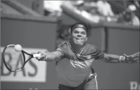  ?? The Canadian Press ?? Milos Raonic returns to Miomir Kecmanovic of Serbia at the BNP Paribas Open on Thursday in Indian Wells, Calif.