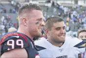  ?? JOHN CORDES — THE ASSOCIATED PRESS FILE ?? Houston Texans defensive end J.J. Watt (99) stands on the field next to his brother San Diego Chargers fullback Derek Watt (34) after the Texans defeated the Los Angeles Chargers 27to 20in an NFL game in Carson on Sept. 22, 2019.
