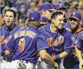  ?? JULIE JACOBSON / ASSOCIATED PRESS ?? Wilmer Flores (center right) is mobbed by teammates after hitting a walk-off solo home run during the 12th inning to defeat the Washington Nationals 2-1 on July 31, just two days after Flores thought he had been traded.