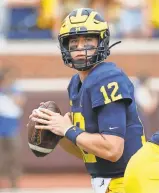  ?? RICK OSENTOSKI/USA TODAY SPORTS ?? Cade McNamara threw for two touchdowns in Michigan’s opener.