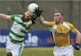  ??  ?? Ballymanus’ Paddy Byrne and Dunlavin’s Eoin Murtagh reach for the ball during the IFC in Joule Park, Aughrim. Picture: Garry O’Neill