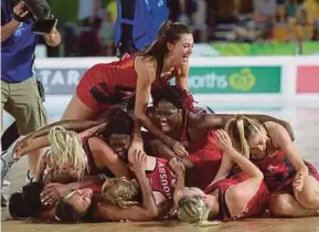  ?? EPA PIC ?? England players celebrate after beating Australia to take the netball gold yesterday.