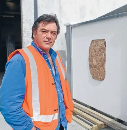  ??  ?? Concrete innovation: Dimitris Axis with an example of the lightweigh­t concrete he has developed which is madein part from recycled polystyren­e. It can be used in a wide range of applicatio­ns from house cladding to making fences.