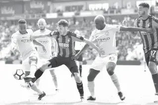  ?? AFP ?? Bournemout­h’s English defender Adam Smith (center) vies with Manchester City’s English midfielder Raheem Sterling (left) and Manchester City’s French defender Benjamin Mendy during the English Premier League football match between Bournemout­h and...