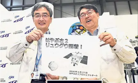  ?? — AP ?? Probe into the ‘Palace’: Professor Takashi Kubota (right) and Associate Professor Makoto Yoshikawa from Jaxa posing for a photo after asteroid explorer Hayabusa2 arrived at the asteroid of Ryugu, in Sagamihara, near Tokyo.