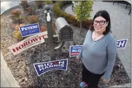  ?? Paul Sancya / Associated Press ?? Lori Goldman poses for a portrait next to campaign signs outside her home in Bloomfield Village, Mich., Oct. 9. For most of her life, until 2016, Goldman had been politicall­y apathetic. Had you offered her $1 million, she says, she could not have described the branches of government in any depth. She voted, sometimes.