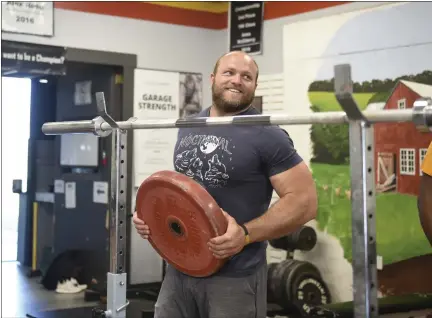  ?? LAUREN A. LITTLE — READING EAGLE ?? Schuylkill Valley grad Dane Miller, the Berks record holder in the shot put, has turned his Garage Strength gym into a launching pad for championsh­ip athletes.