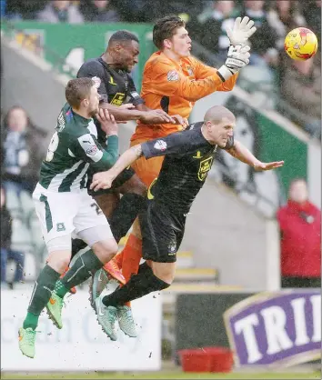  ??  ?? UNDER PRESSURE: Ryan Brunt challenges Bury goalkeeper Nick Pope for the ball