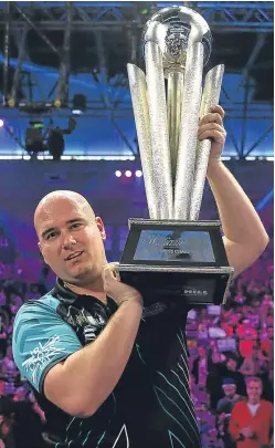  ?? Picture: PA. ?? PDC world champion Rob Cross with the trophy.