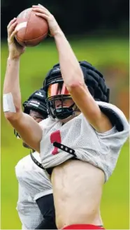  ?? STAFF PHOTO BY C.B. SCHMELTER ?? Signal Mountain’s Drew Lowry catches a ball against teammate Travion Williams during practice at Signal Mountain Middle/High School.