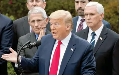  ?? The Associated Press ?? President Donald Trump, accompanie­d by Dr. Anthony Fauci, director of the National Institute of Allergy and Infectious Diseases, left, and Vice President Mike Pence, right, speaks during a news conference about the coronaviru­s in the Rose Garden at the White House, Friday, in Washington.