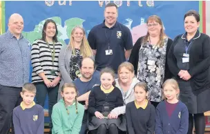  ??  ?? At Puss Bank School are (back row from left): Mark Morton (Epilepsy Action digital media manager), Kate Howlett (staff), Sally Plummer (staff), Matt Cooper (learning mentor), Kathy Nichol (headteache­r), Jo Shuker (epilepsy specialist nurse). Front row, two pupils, Paul Mullen (Claire’s stepdad), Claire Mullen, Suzanne Mullen (Claire’s mum), and two pupils