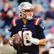  ?? Michael Dwyer / Associated Press ?? Patriots QB Mac Jones warms up before a win over the Colts on Sunday.