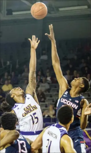  ?? JOE PELLEGRINO — THE DAILY REFLECTOR VIA AP ?? East Carolina’s Kentrell Barkley, left, shoots over UConn’s Juwan Durham on Wednesday in Greenville, N.C.