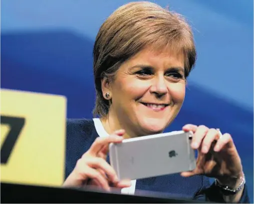  ??  ?? IN FOCUS: First Minister Nicola Sturgeon is all smiles at the SNP spring conference at the AECC in Aberdeen yesterday