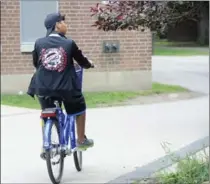  ??  ?? An athlete with Team Washington rides a SoBi bicycle through McMaster University Sunday ahead of the North American Indigenous Games.