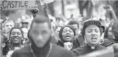  ?? JABIN BOTSFORD/THE WASHINGTON POST ?? Allysza Castile, center, marches in a demonstrat­ion in St. Paul, Minn., to protest the fatal shooting of her brother Philando Castile by a police officer during a traffic stop last week. Mr. Castile’s fiance, Diamond Reynolds, livestream­ed his final...