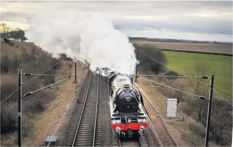  ?? Danny Lawson ?? The Flying Scotsman, renamed as Sir William McAlpine, near Colton Junction in Yorkshire yesterday, during the Scotsman Salute, a memorial trip from London King’s Cross to York in honour of Sir William McAlpine who is remembered for saving the Flying Scotsman when he paid for the locomotive to be restored and brought back into main line operation. Two generation­s of express locomotive­s, past and present lined up side by side in a unique event to honour Sir William McAlpine, Flying Scotsman’s former owner who died last year