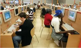  ?? Photograph: Mario Tama/Getty ?? ‘On Yahoo Answers, humans rather than algorithms provided informatio­n and vetted it for one another.’ An internet cafe in New York in 2002.