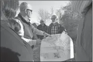  ?? NWA Democrat-Gazette/J.T. WAMPLER ?? Tom Hennelly (center left) of Crafton Tull shows a map of a developmen­t planned Monday for northwest Fayettevil­le to Parks Board members Nicole Claesen (left) and Joel Freund (center right) and park planner Ken Eastin. Joe Fifer (center) with Crafton Tull looks on.