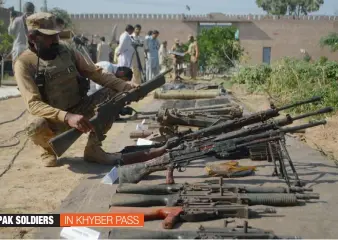  ??  ?? A member of the Pakistani paramilita­ry forces examines an assault rifle they recovered during a crackdown in the Pakistani tribal area of Bara, in the Khyber Agency, on Thursday.