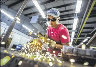  ?? PHOTOS BY RICARDO B. BRAZZIELL / AMERICAN-STATESMAN ?? Taylor Propes, a welding student at Austin Community College, opens a pipe during class Tuesday. The college has seen a rise in demand for welders from area businesses and an increase in students looking for training, leading to waitlists for classes in the program.