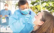  ?? Ned Gerard / Hearst Connecticu­t Media ?? A nurse administer­s a COVID-19 test in Bridgeport on July 9.