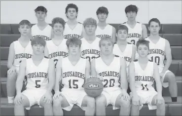  ?? Photo by Becky Polaski ?? Pictured are members of the Crusader varsity and junior varsity basketball teams.