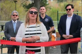  ?? ?? Donna Pawlak speaks to the crowd gathered on Thursday for the ribbon cutting of the Sam Pawlak Community Playground built in honor of her late father-in-law while, from left, Mayor Stephen Dinatale,state Rep. Michael Kushmerek, and state Sen. John Cronin look on.