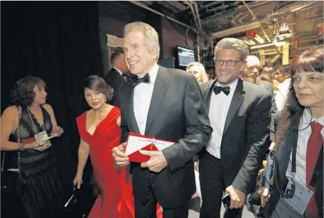  ?? Photograph­s by Al Seib Los Angeles Times ?? PRESENTER Warren Beatty walks backstage. Before announcing the best picture winner, Beatty was given the wrong envelope, leading to one of the most shocking moments in Oscar history. “Moonlight,” with a budget of well under $5 million, was considered...