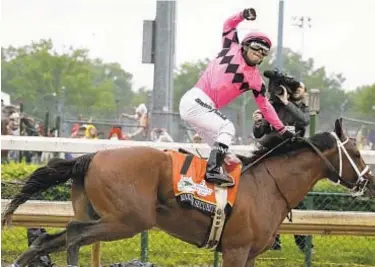  ?? AP ?? In this file photo, Luis Saez rides Maximum Security across the finish line during the Kentucky Derby in May. Country House was declared the winner after Maximum Security was DQ’d following a review by race stewards. Maximum Security has another inquiry but wins the Haskell Invitation­al on Saturday.