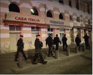  ?? (AP/Daniel Cole) ?? Police officers enforce a curfew Saturday in Marseille in southern France. France is deploying 12,000 police officers to enforce a new curfew that took effect Friday night.