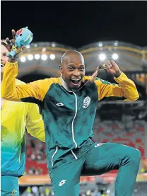  ?? Picture: GALLO IMAGES ?? PODIUM PARTY: South Africa’s Luvo Manyonga, left, jumps for joy on the podium aftr securing the gold at the Sydney Games