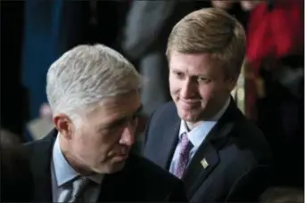  ?? JABIN BOTSFORD — THE WASHINGTON POST VIA AP, FILE ?? In a Monday file photo, Nick Ayers, right, listens as Supreme Court Associate Justice Neil Gorsuch waits for the arrival of the casket for former President George H.W. Bush to lie in State at the Capitol on Capitol Hill in Washington.