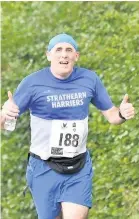  ??  ?? Thumbs up The Strathearn Harriers were well represente­d in the race