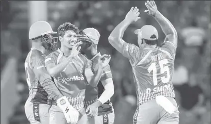  ??  ?? Gudakesh Motie, second left, of the Guyana Amazon Warriors, celebrates the dismissal of Sharmarh Brooks of the Jamaica Tallawahs yesterday. (Photo Randy Brooks-CPLT20/Getty Images)