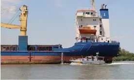  ?? ?? A cargo ship and a Ukrainian coastguard vessel ply the Danube–Black Sea canal. Photograph: Operationa­l Command South Press Service/Reuters