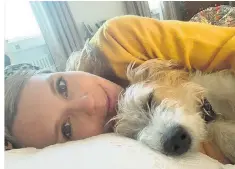  ??  ?? Carrie Symonds, who is selfisolat­ing, last week posted a picture on Instagram of herself with the couple’s dog Dilyn. Boris Johnson, right, claps NHS staff