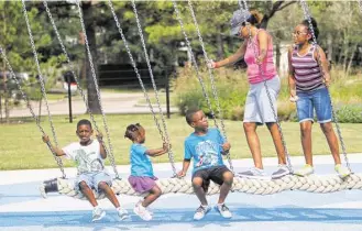  ?? Steve Gonzales photos / Houston Chronicle ?? Andrea Rogers swings with her children, from left, Blake, 7, Eden, 3, Chase, 10, and Dylan, 11.